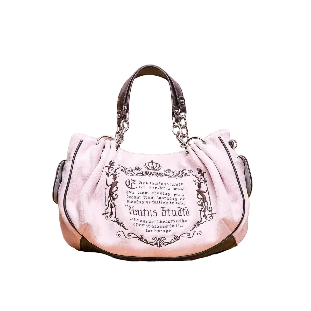 Pink handbag with decorative text on a pink cushion
